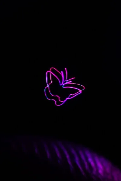 Colored butterfly traces from the BYU optical-trap display, shown in the researchers’ original demonstration photograph.