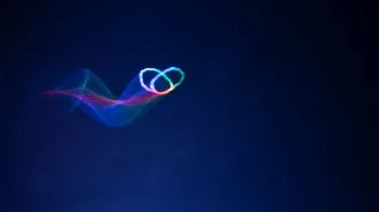 A small colored butterfly-like trace from the Sussex acoustic-trap demonstration against a dark blue background.